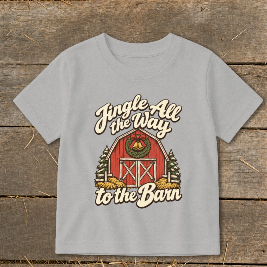 Grey t-shirt with a red barn, Christmas wreath, bells, and text "Jingle All the Way to the Barn".