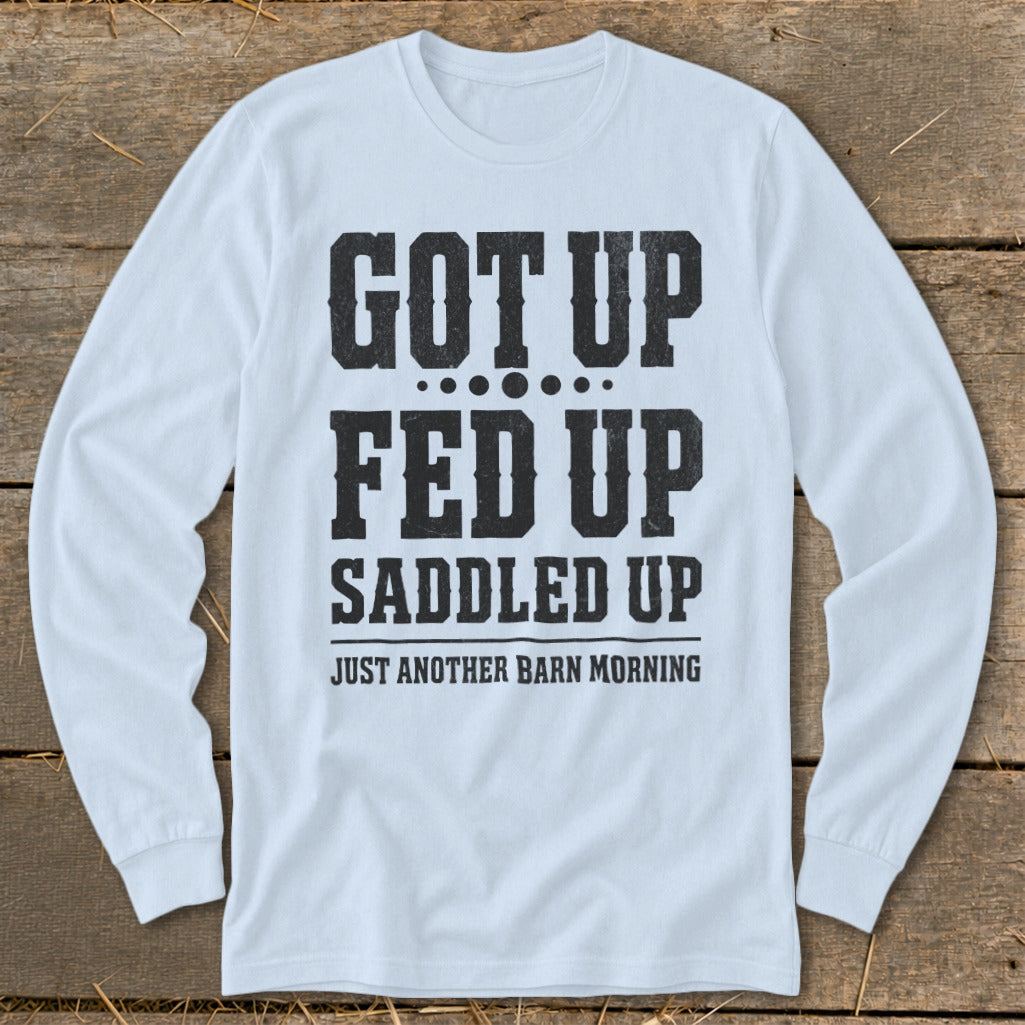Light blue long-sleeve shirt with "Got Up, Fed Up, Saddled Up, Just Another Barn Morning" text.