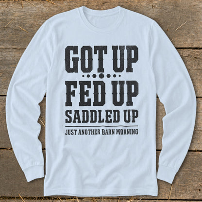 Light blue long-sleeve shirt with "Got Up, Fed Up, Saddled Up, Just Another Barn Morning" text.