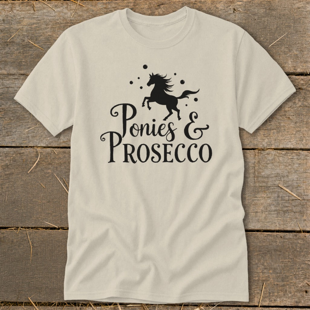 Light-colored t-shirt with black graphic of a prancing horse and text "Ponies & PROSECCO".