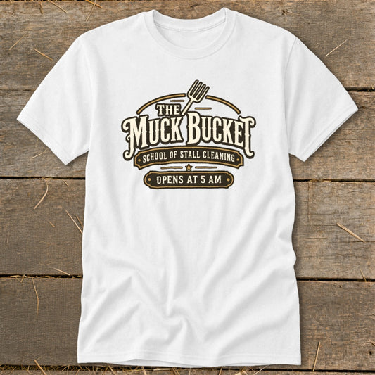 White t-shirt with "The Muck Bucket School of Stall Cleaning Opens at 5 AM" logo.