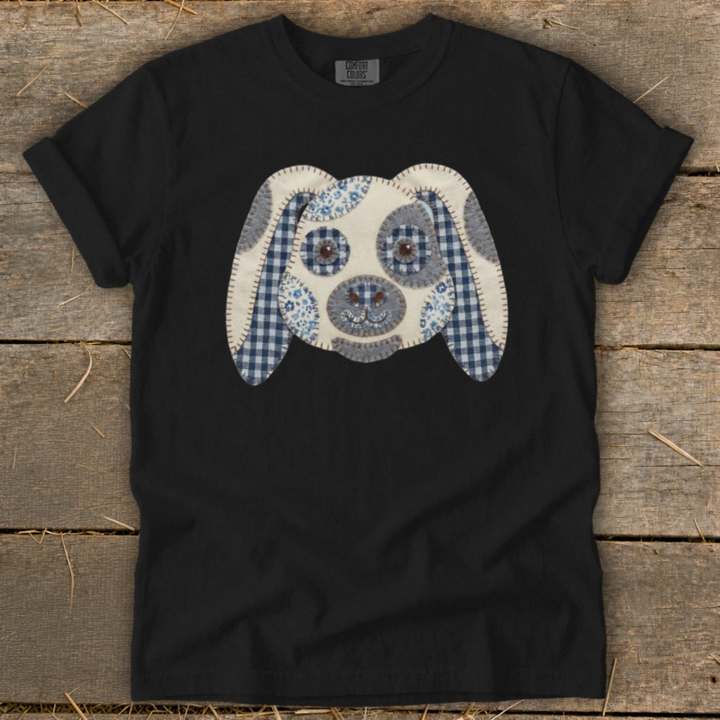 Black t-shirt featuring a fabric appliqué of a dog's face with blue gingham.