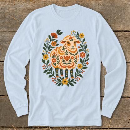 Light blue long-sleeve shirt with a colorful folk art sheep and floral wreath design.