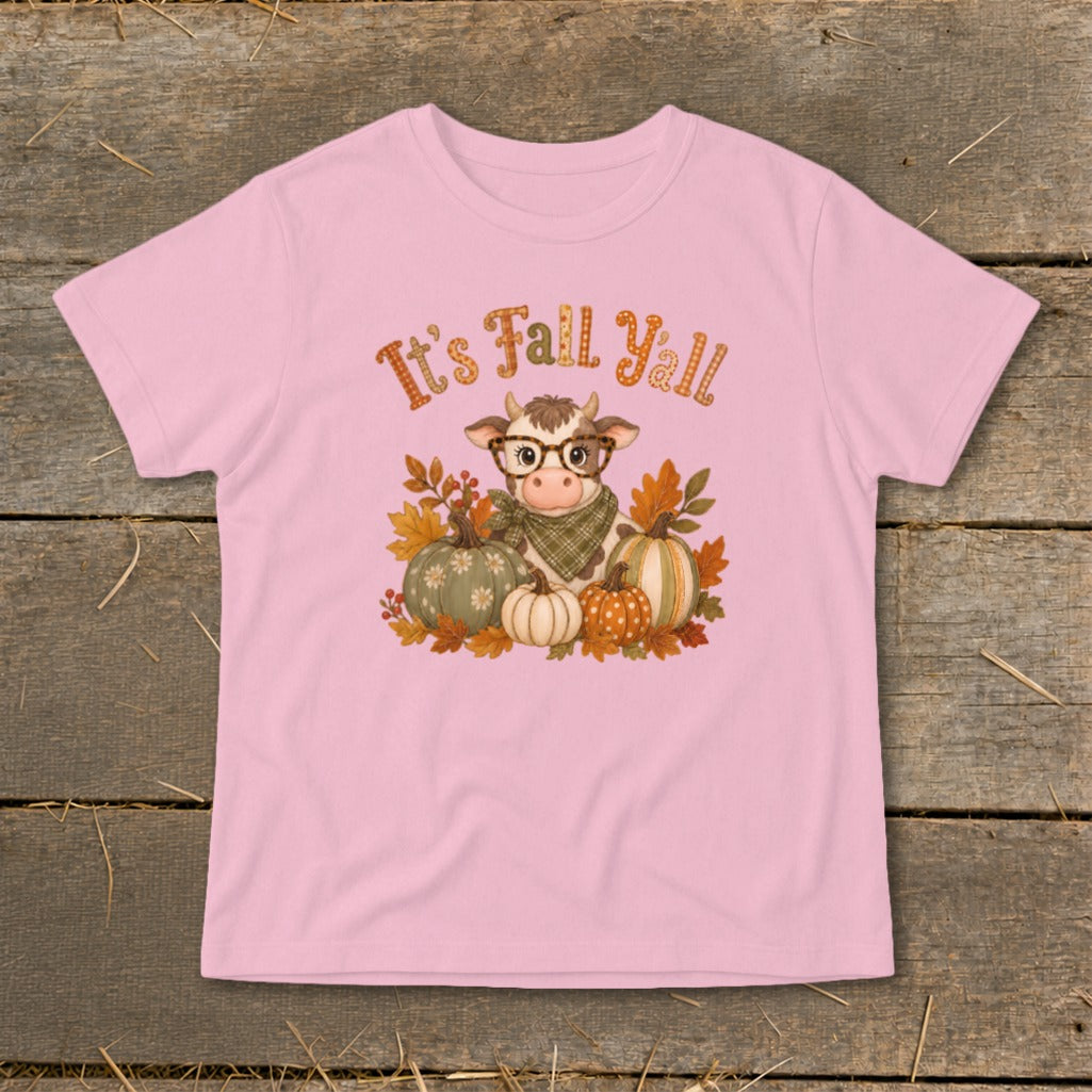 Pink t-shirt with a cow, pumpkins, and autumn leaves graphic that says "It's Fall Yall."