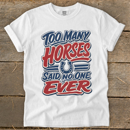 White t-shirt with "Too Many Horses Said No One Ever" text and horseshoe graphic.