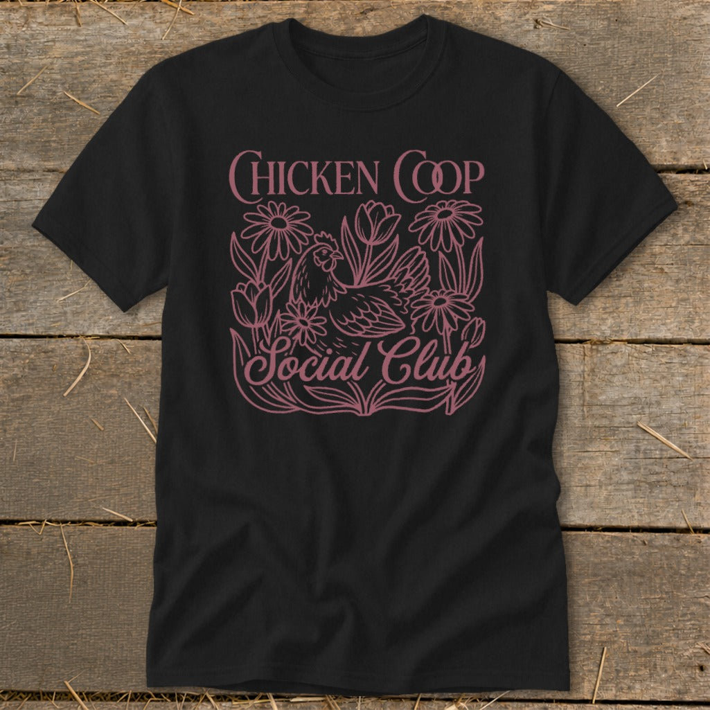 Black t-shirt with pink "Chicken Coop Social Club" text and chicken and flower graphic.