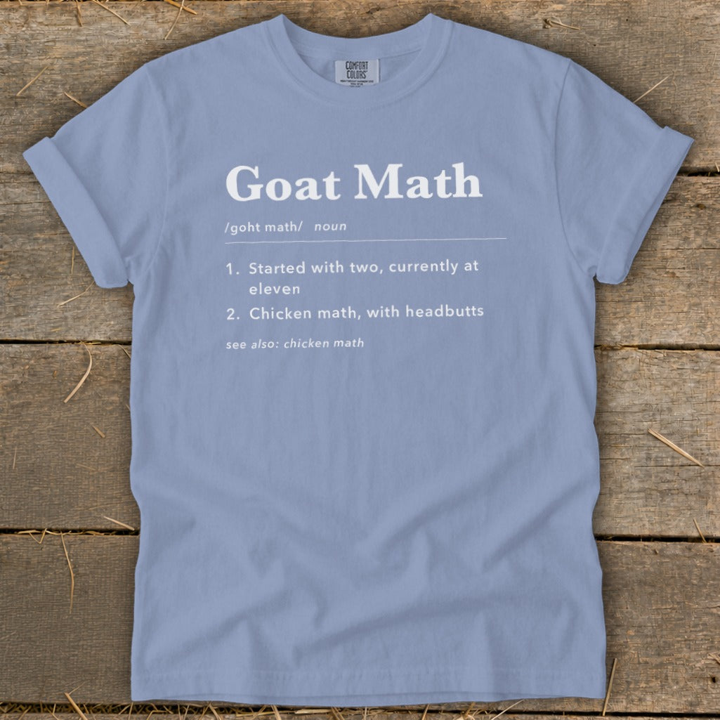 Light blue t-shirt with "Goat Math" definition and related phrases printed in white.