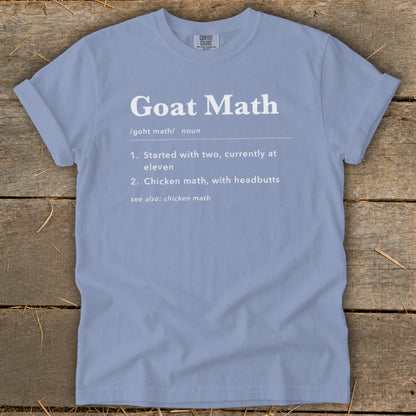Light blue t-shirt with "Goat Math" definition and related phrases printed in white.