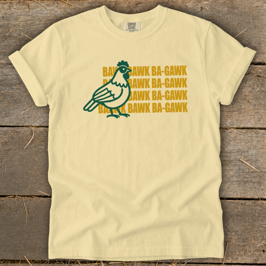Light yellow t-shirt with a green chicken graphic and repeated "Bawk Ba-Gawk" text.