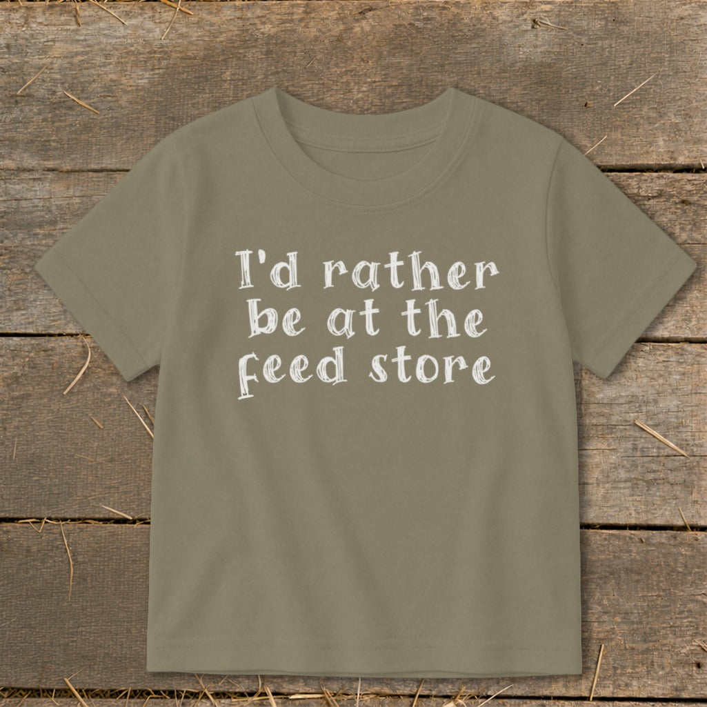 Green t-shirt with white text reading "I'd rather be at the feed store."