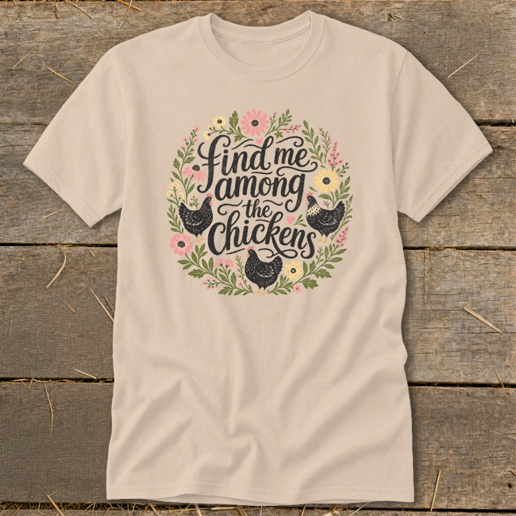 Beige t-shirt with floral wreath and text "Find me among the chickens" and black chickens.