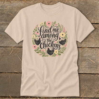 Beige t-shirt with floral wreath and text "Find me among the chickens" and black chickens.
