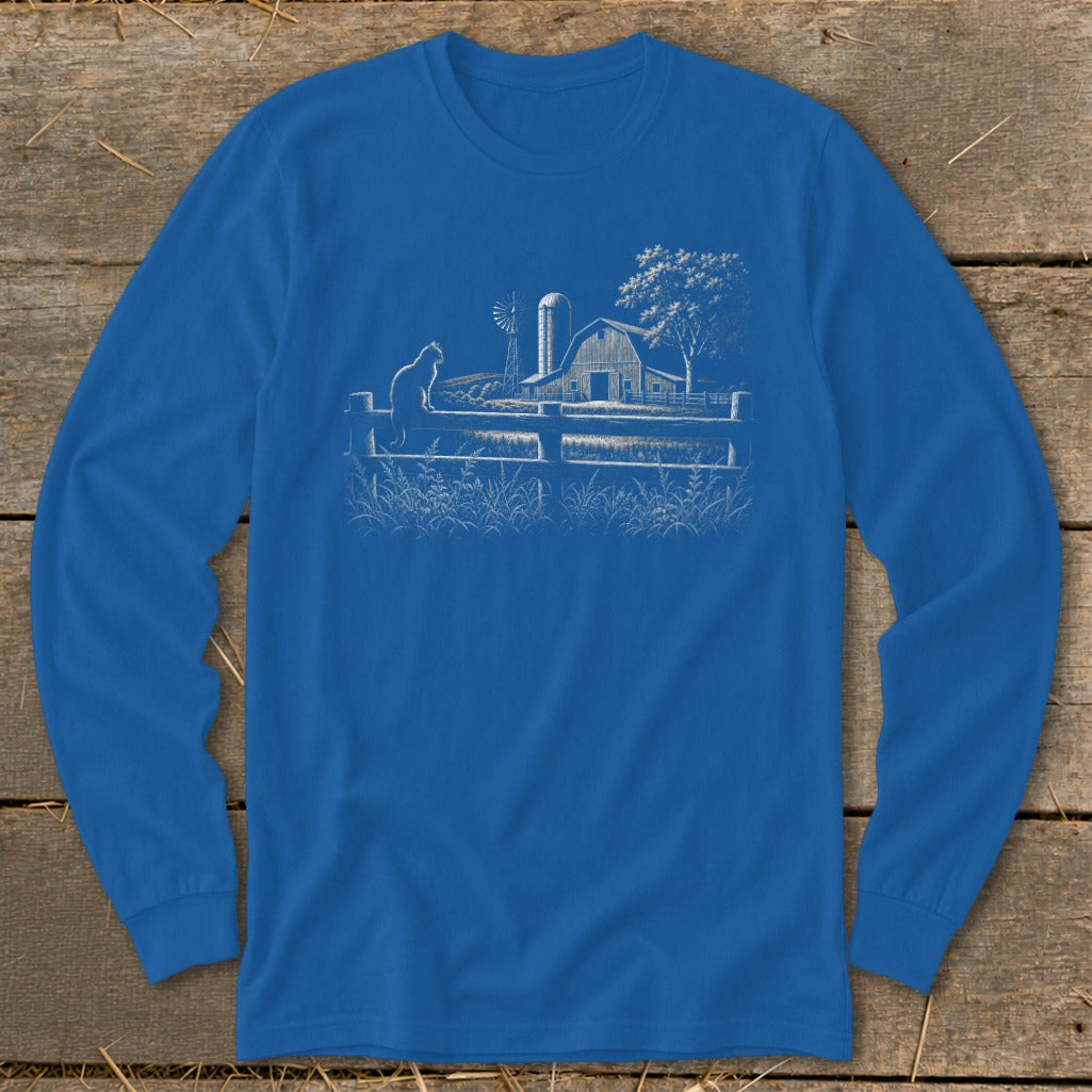 Blue long sleeve shirt with a white line drawing of a cat on a fence, barn, and windmill.