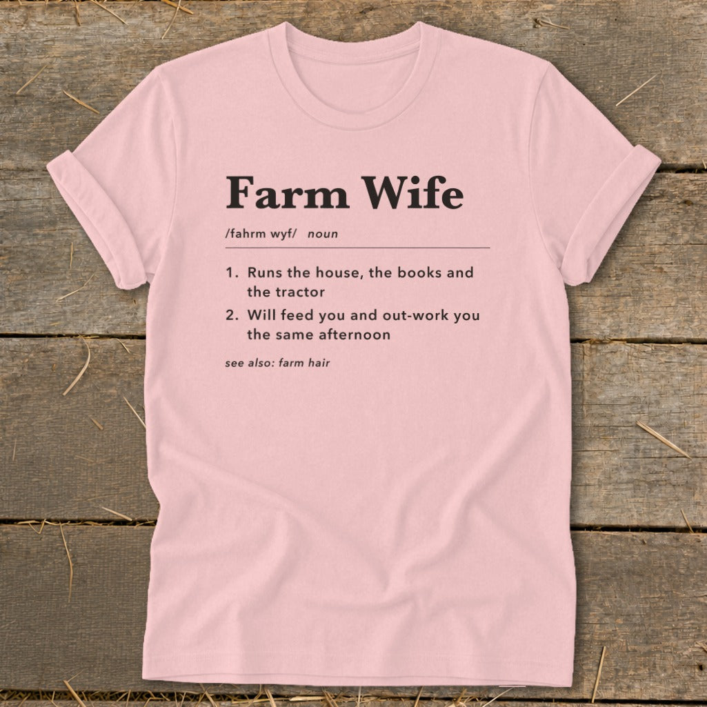 Pink t-shirt with "Farm Wife" definition: runs house, books, tractor, feeds and out-works you.