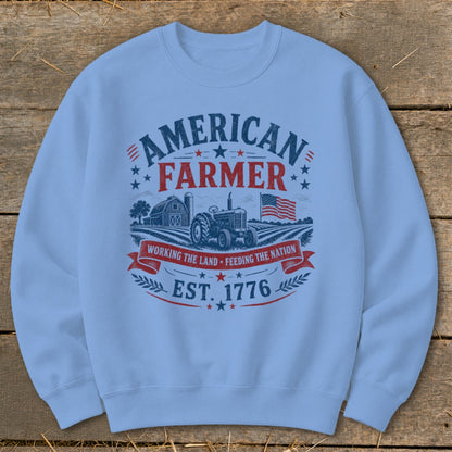 Light blue sweatshirt with "American Farmer" graphic, tractor, barn, and American flag.