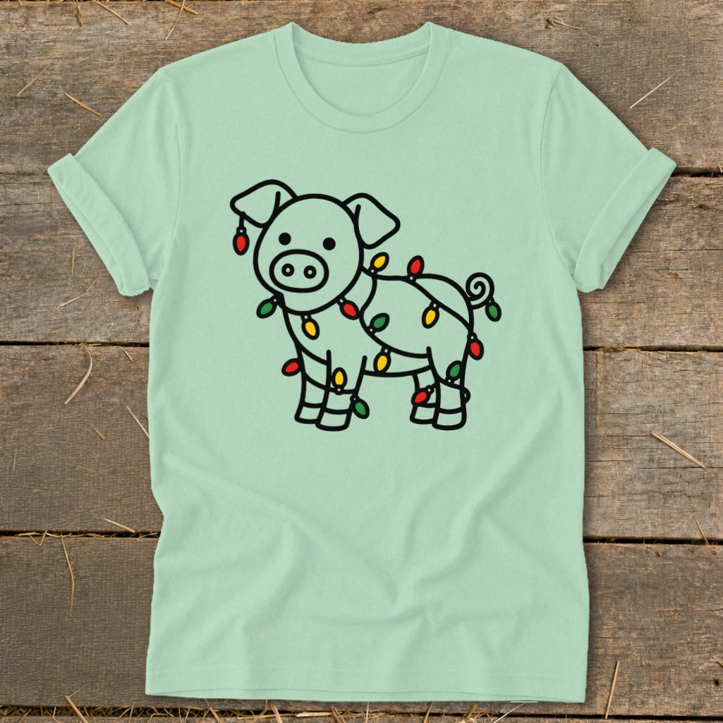 Light green short-sleeve t-shirt with a black outline graphic of a pig tangled in Christmas lights.