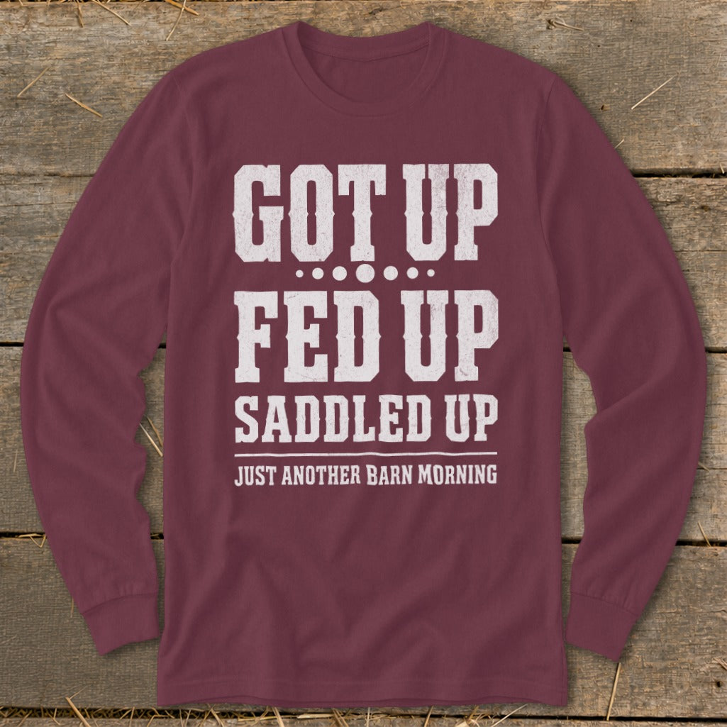 Maroon long-sleeve shirt with white text "Got Up Fed Up Saddled Up Just Another Barn Morning".