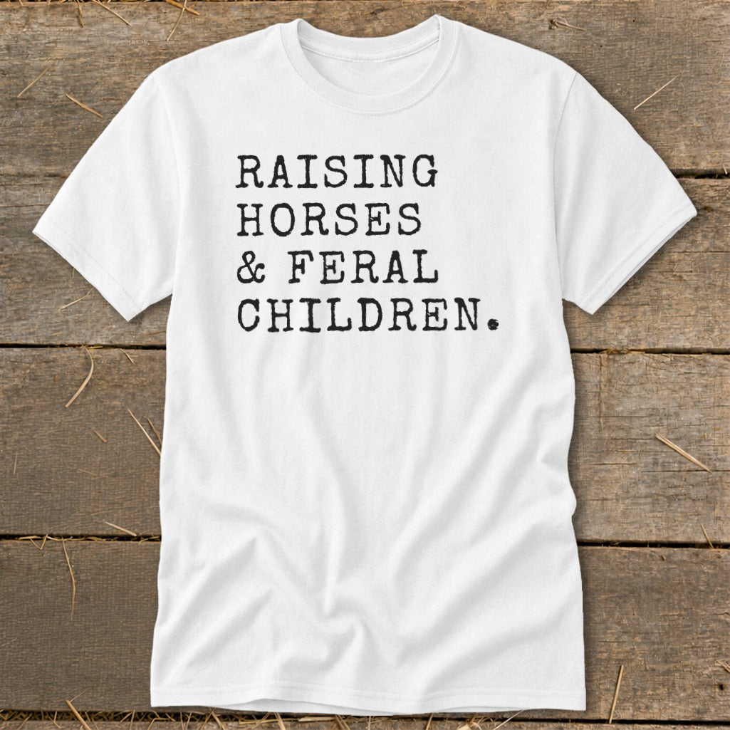 White t-shirt with black text "RAISING HORSES & FERAL CHILDREN."
