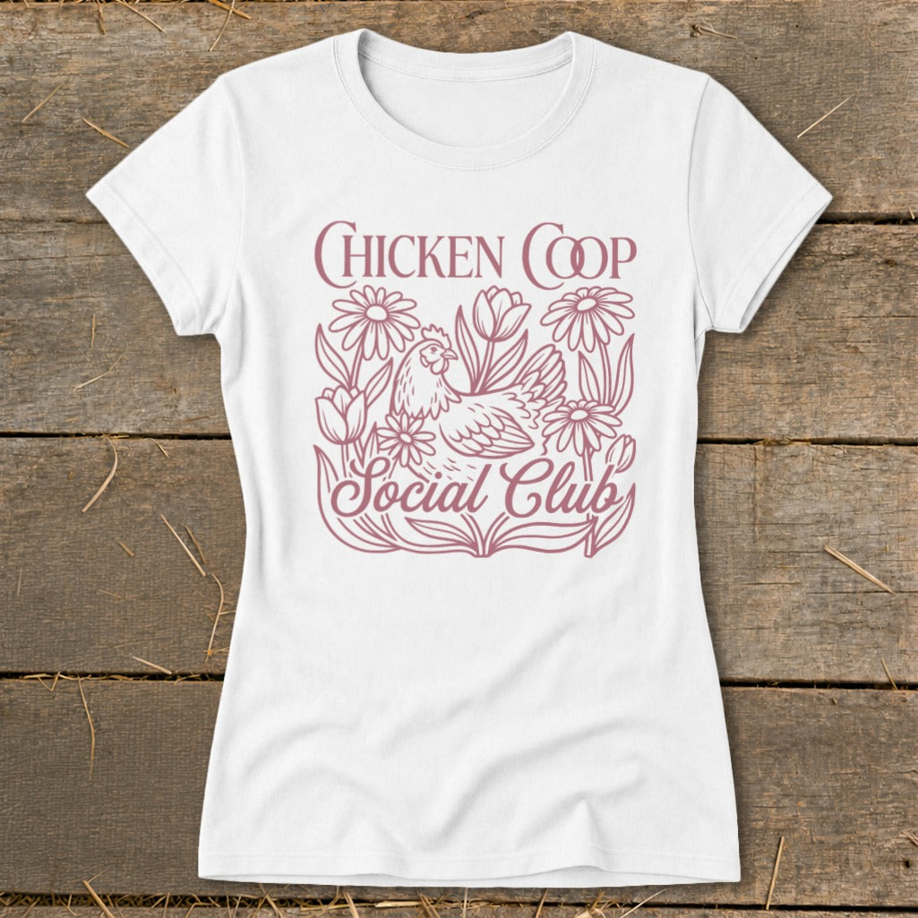 White t-shirt with "Chicken Coop Social Club" text and chicken with flowers graphic.