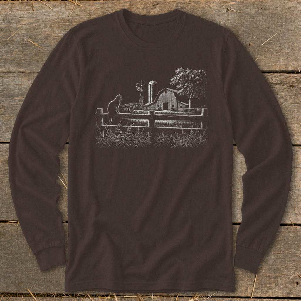 Long-sleeved brown t-shirt with a white line drawing of a cat on a fence at a farm.