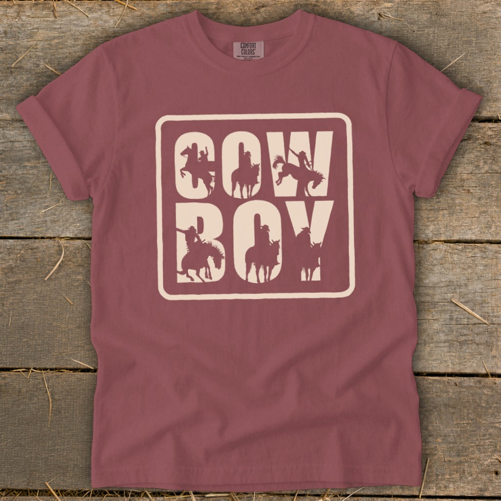 Maroon t-shirt with "COW BOY" in cream lettering and cowboy silhouettes.