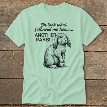 Light green t-shirt with a sketch of a lop-eared rabbit and text reading "Oh look what followed me home... ANOTHER RABBIT".