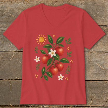 Red t-shirt with a sun and apple branch illustration with red apples and white flowers.
