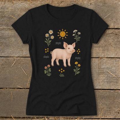 Black t-shirt with a light pink pig surrounded by flowers and a sun.