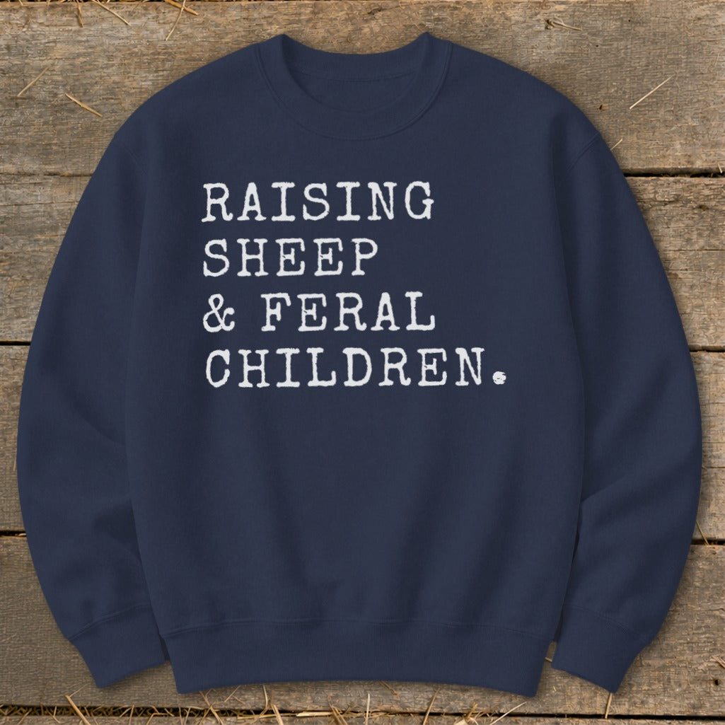 Navy sweatshirt with white text: Raising sheep & feral children.