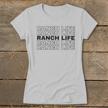 A light gray crewneck t-shirt with the text RANCH LIFE printed in stacked rows.