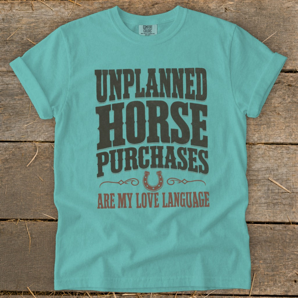 Teal t-shirt with "Unplanned Horse Purchases Are My Love Language" text and horseshoe graphic.