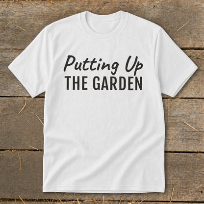 White t-shirt with black text that reads "Putting Up THE GARDEN".