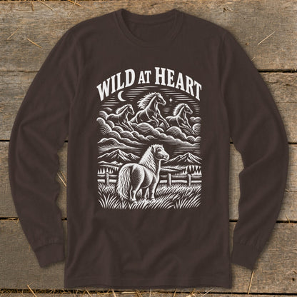 Dark brown long-sleeve t-shirt with a white graphic print featuring horses, mountains, and the text WILD AT HEART.