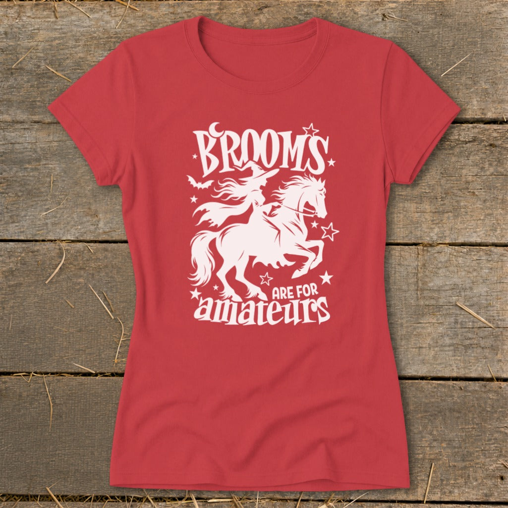 Red t-shirt with white graphic of witch riding a horse, saying "Brooms are for amateurs".