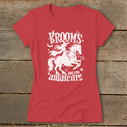 Red t-shirt with white graphic of witch riding a horse, saying "Brooms are for amateurs".