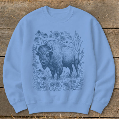 Light blue crewneck sweatshirt with a blue line drawing of a bison surrounded by wildflowers.