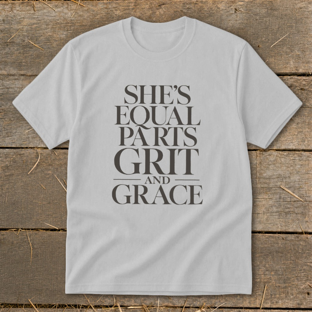 Light gray t-shirt with text "SHE'S EQUAL PARTS GRIT AND GRACE".