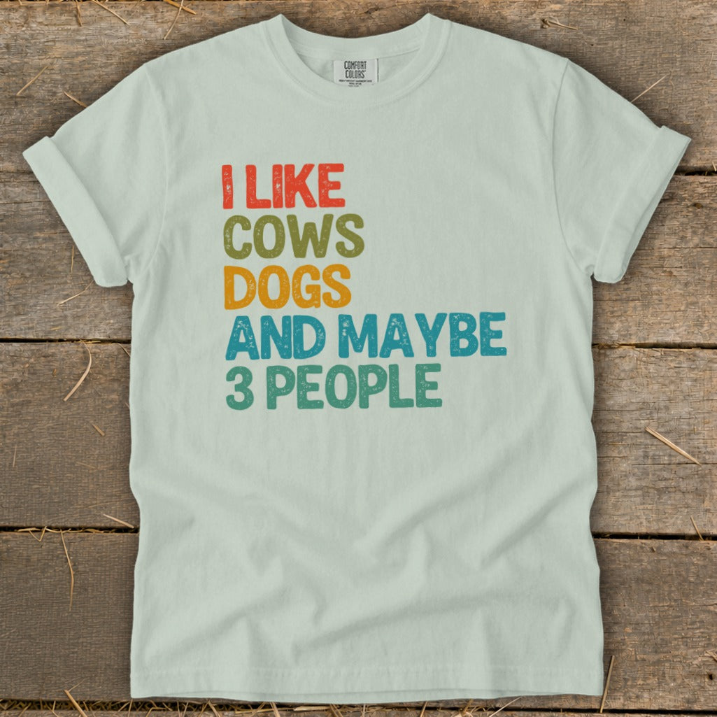 Light green t-shirt with "I LIKE COWS DOGS AND MAYBE 3 PEOPLE" text.