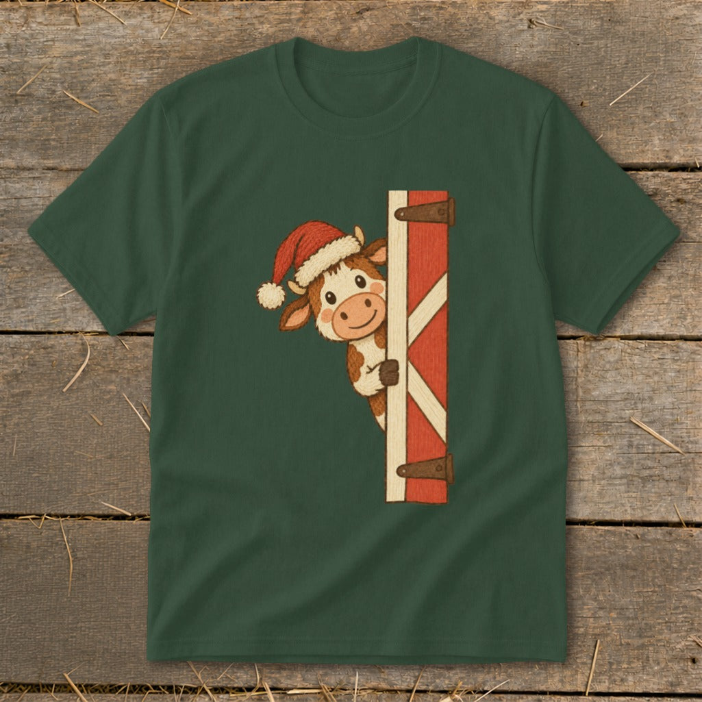 Christmas cow in Santa hat peeking from behind a barn door.