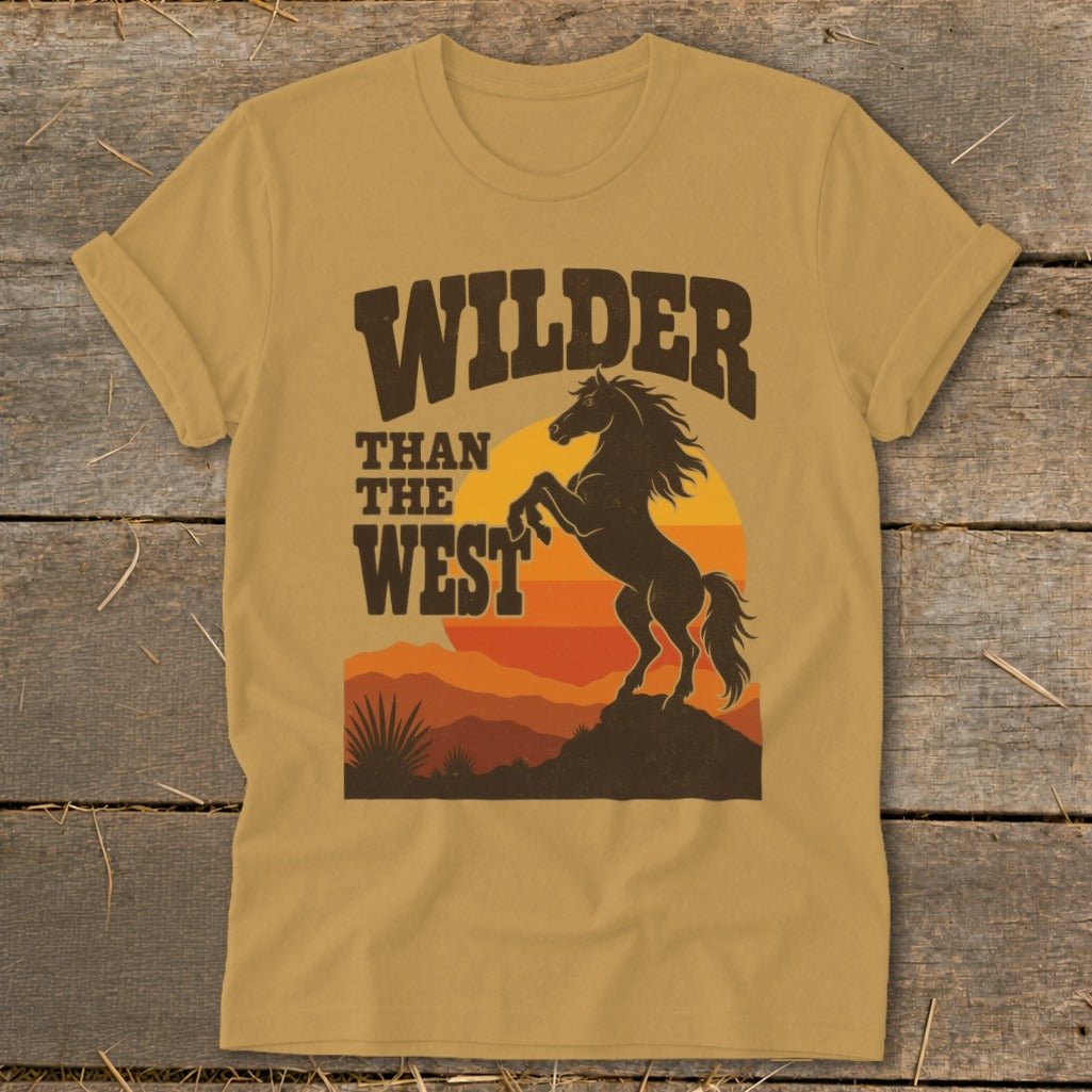 T-shirt with "Wilder Than The West" text and silhouette of a rearing horse at sunset.