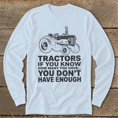 White long-sleeve shirt with tractor graphic and text about tractors.