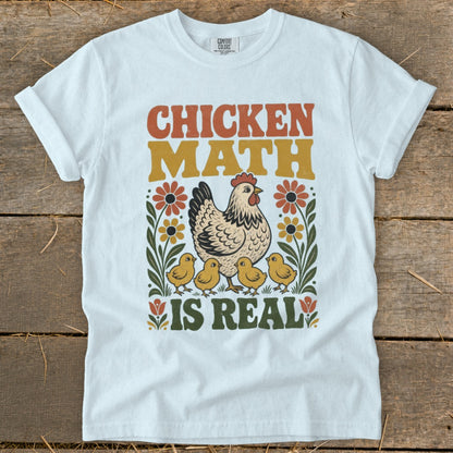 White t-shirt with "CHICKEN MATH IS REAL" text, a hen, and chicks illustration.