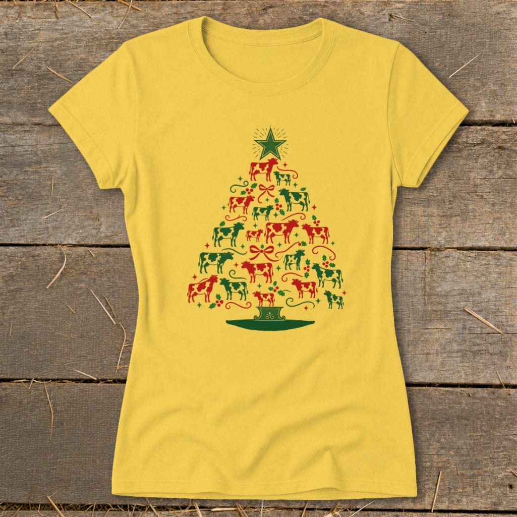 Yellow t-shirt with a Christmas tree made of red and green cows and holly.