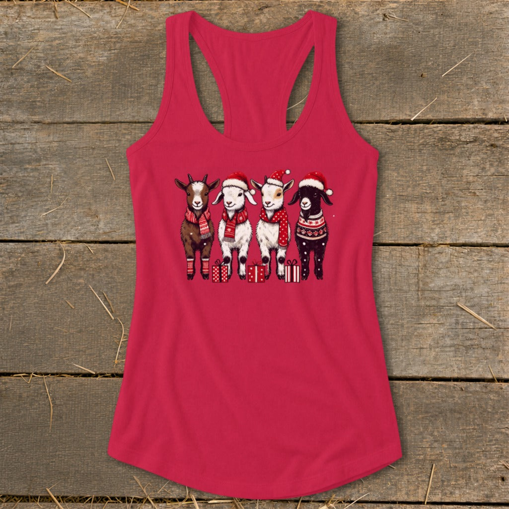 Four goats in Christmas hats and scarves stand with gifts on a pink tank top.