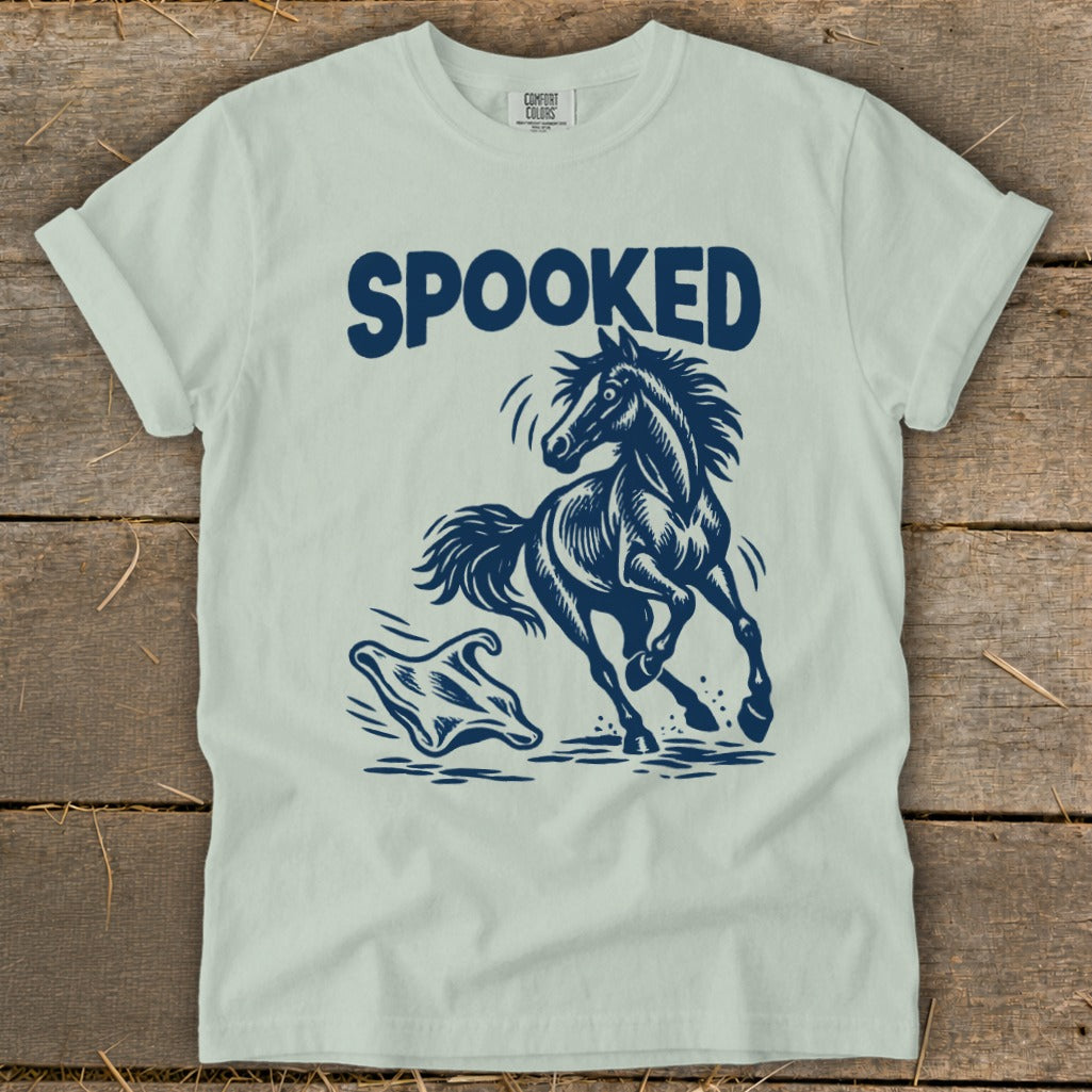 Light blue t-shirt with "SPOOKED" text and a startled horse running from a ghost.