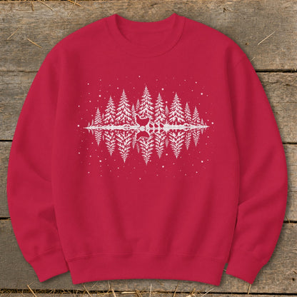 Red sweatshirt with a white reflection of pine trees and snow falling.