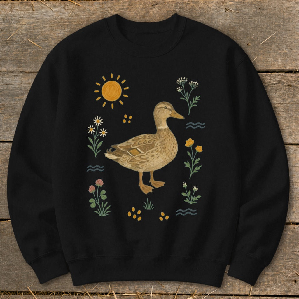 Black sweatshirt with a detailed illustration of a mallard duck surrounded by flowers and sun.