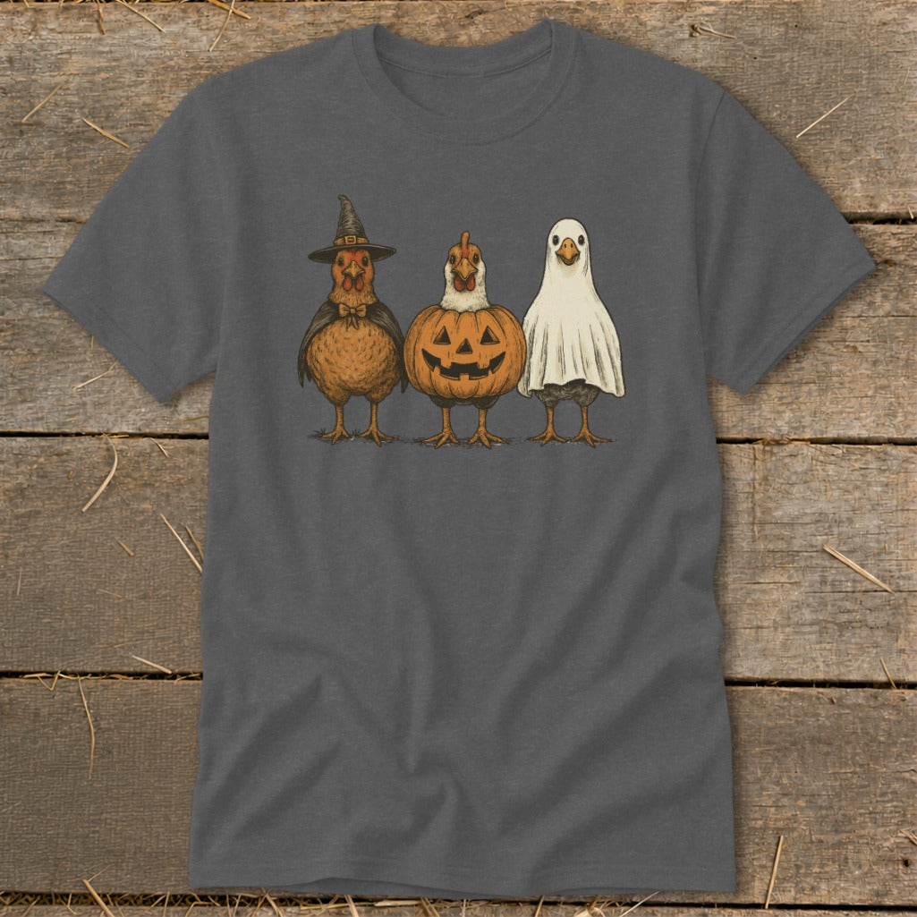 Three chickens dressed in Halloween costumes: witch, pumpkin, and ghost.