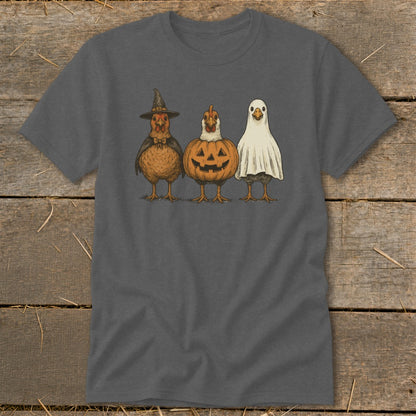 Three chickens dressed in Halloween costumes: witch, pumpkin, and ghost.