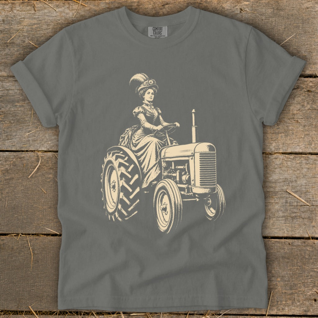 Vintage woman in formal attire driving a tractor with a feathered hat.